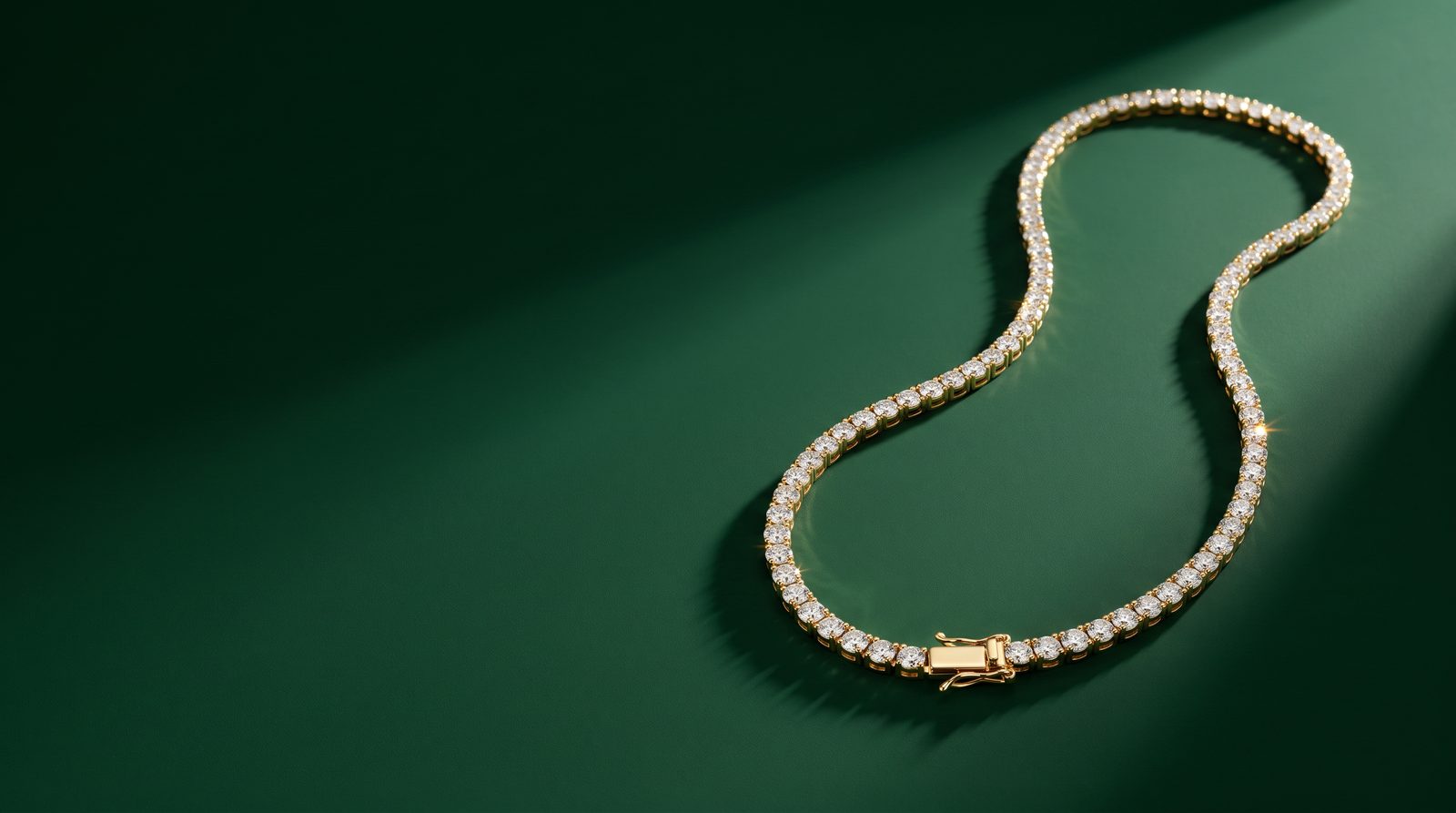 A gold tennis choker on a dark ground
